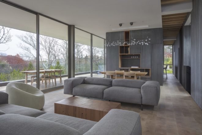 gray living area with gray couch and large windows