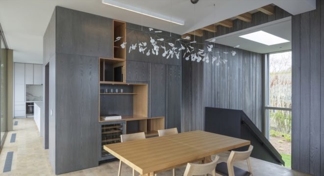 gray built-in shelving and a light wood dining set