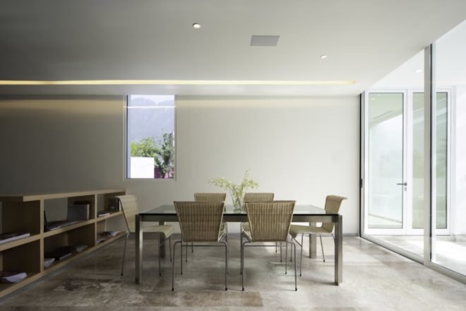 beige dining area with glass table and beige chairs