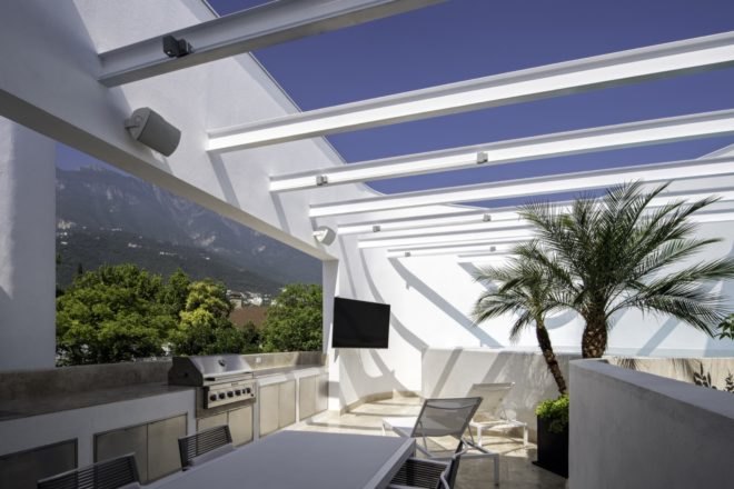 open-air patio with TV and stainless steel grill