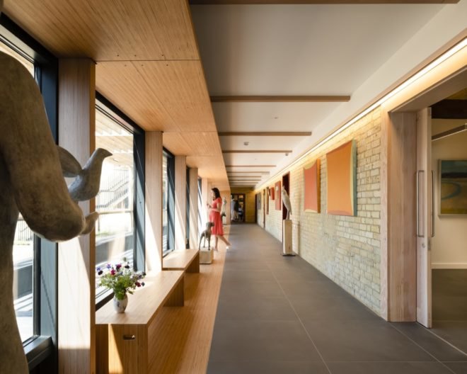 brick hallway with wall art and sculptures