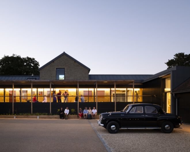 people sitting outside of a renovated barn