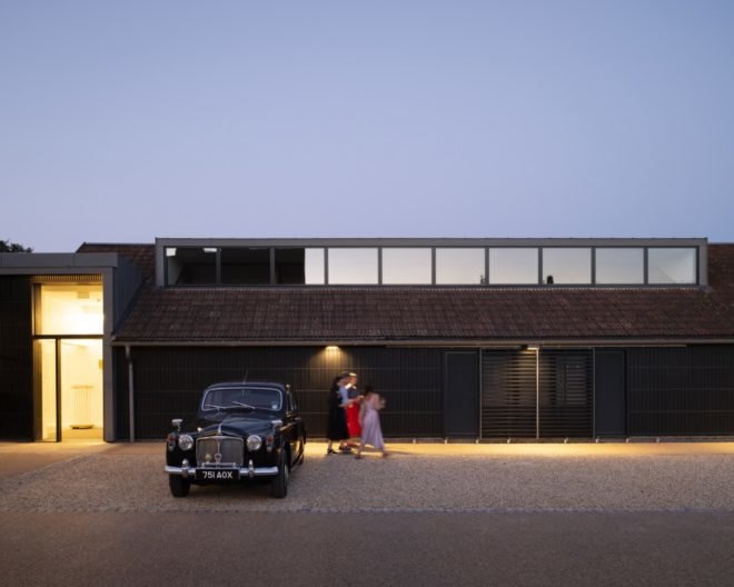 vintage black car in front of a dark building