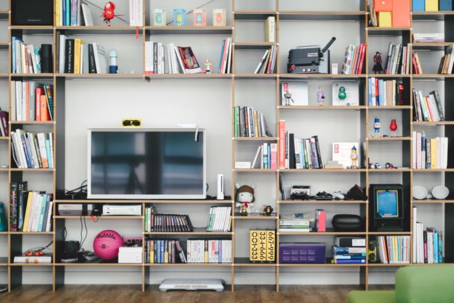 full-height bookshelf with large open space where a flat-screen TV sits