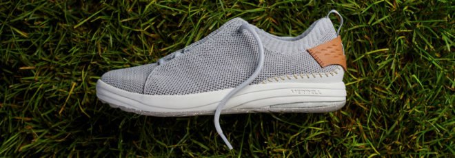 side of gray shoe on grass background