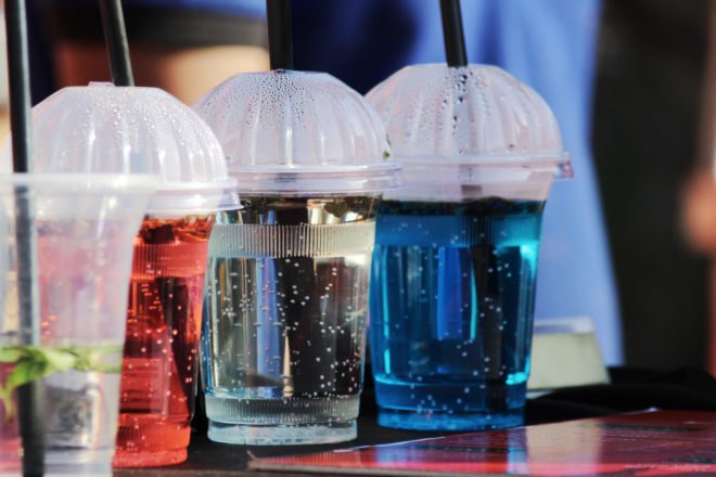 several plastic cups with plastic straws