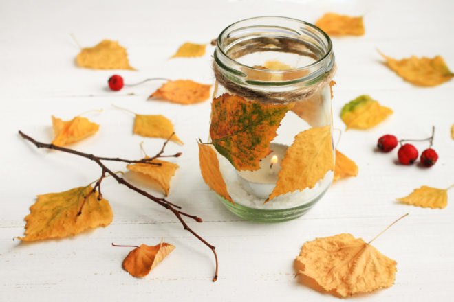 glass jar wrapped in leaves and surrounded by leaves