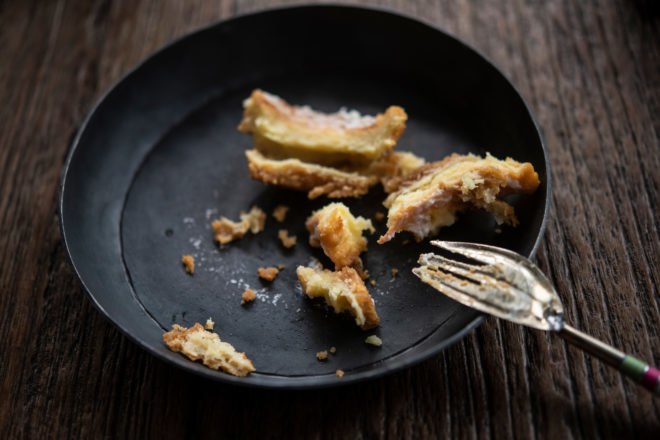 leftover pumpkin pie on black plate