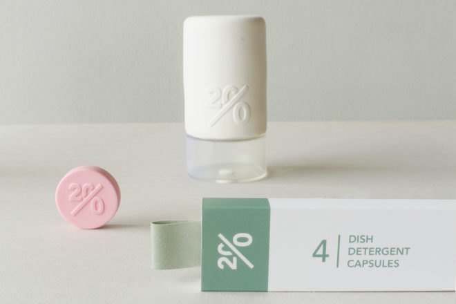 pink cleaning tablet outside a green and white box