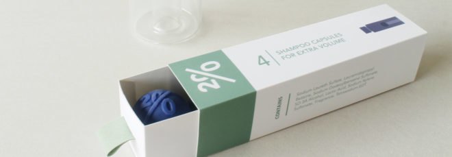 green and white box with blue cleaning tablet