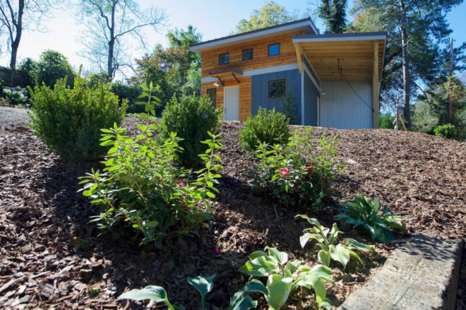 yellow and blue home with front yard