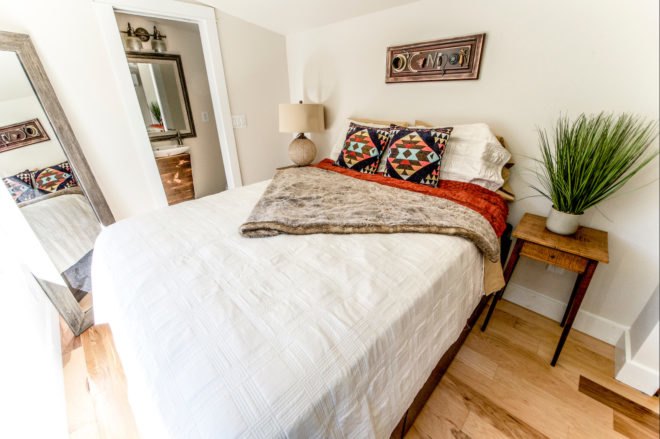 bedroom with white comforter and colorful pillows