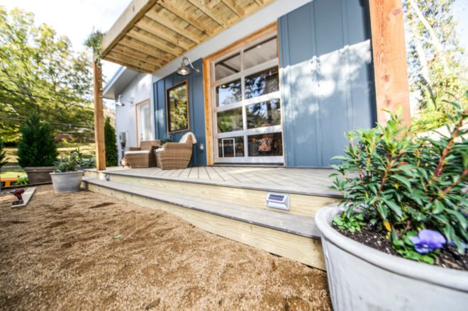 yellow and blue home with back porch