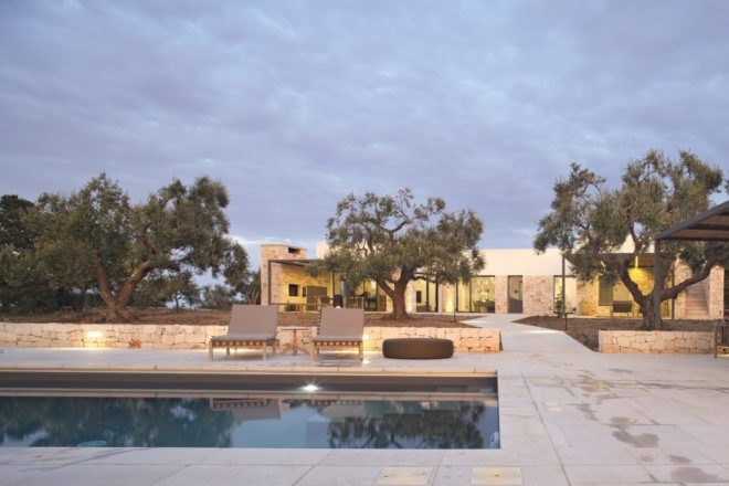 view of the pool and gazebo with the home in the background