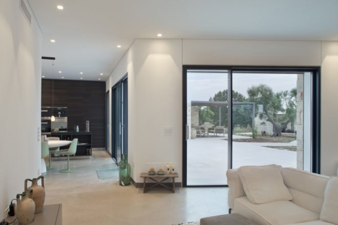 interior of the home with white couches and white walls