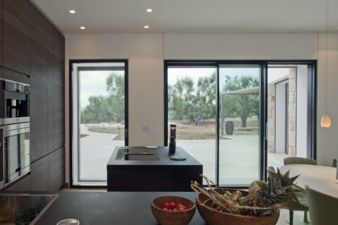 interior of the home with large glass doors and dark wood cabinets