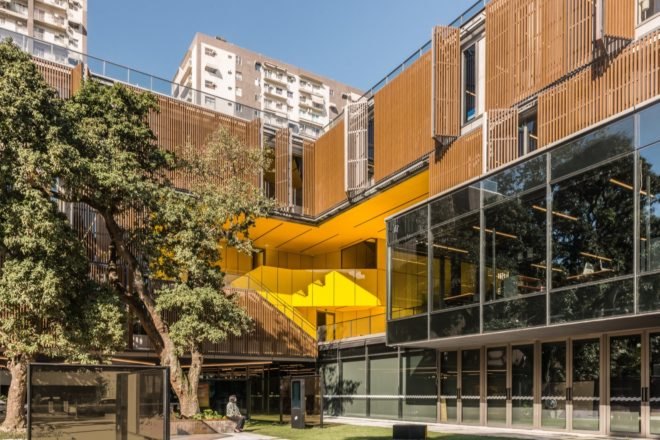 glass building with yellow staircases