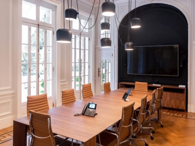 meeting room with long wood table and leather chairs