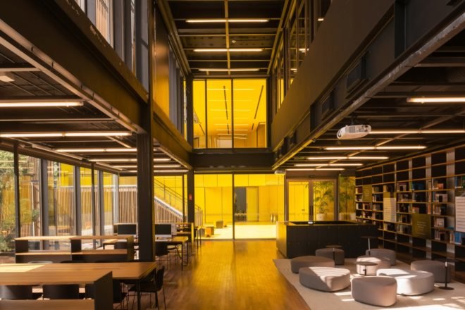 lounge with glass walls and long wood tables