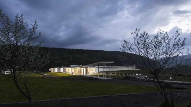 white and glass building lit up at night