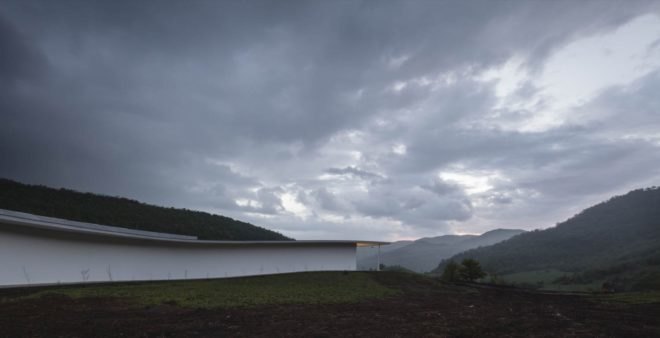white building with mountains in background