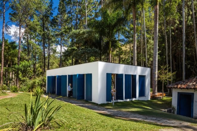 rectangular white building with blue shutters