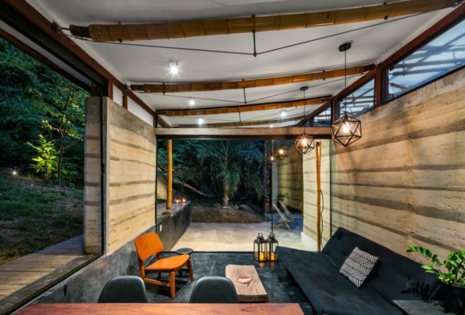 room with black sofa and wood chair