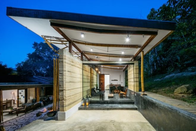 white guesthouse with extended roof over outdoor patio
