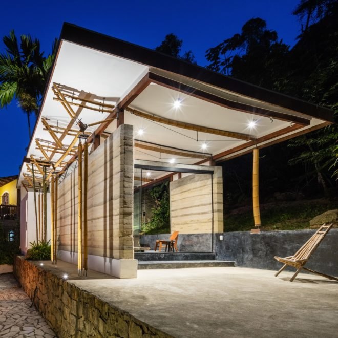 chairs on a patio underneath roof overhangs at night