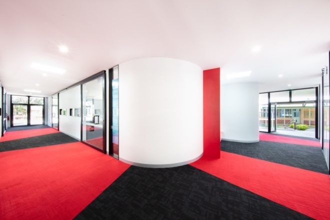 room with white walls and red and black floors