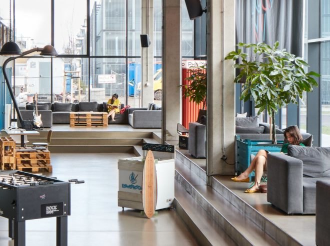 a large lounge area with lots of windows