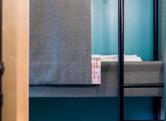 a linen sheet hanging on the side of a bed