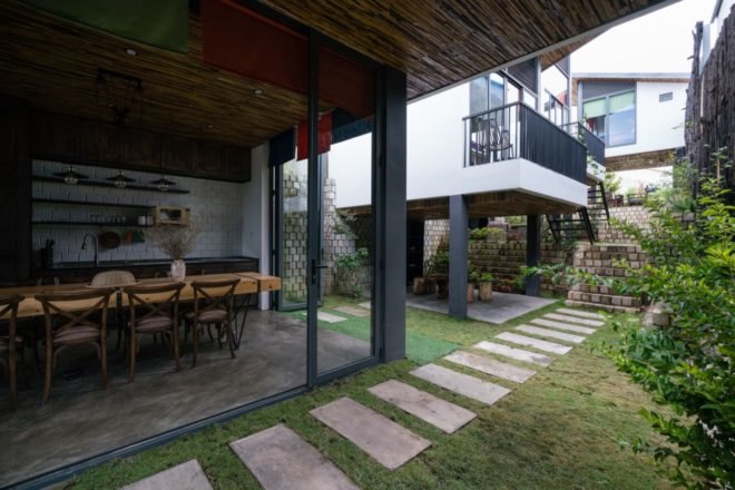 bottom interior of kitchen and dining area with large floor to ceiling windows and entry