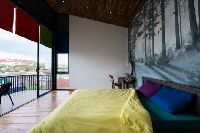 spacious bedroom with large windows and wood floors