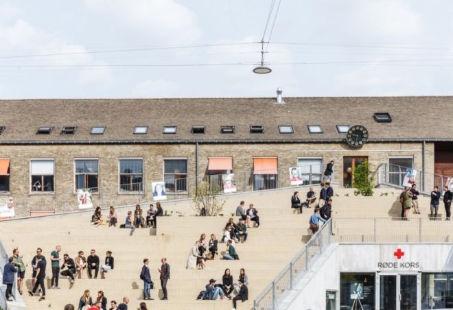 people sitting on steps on a roof