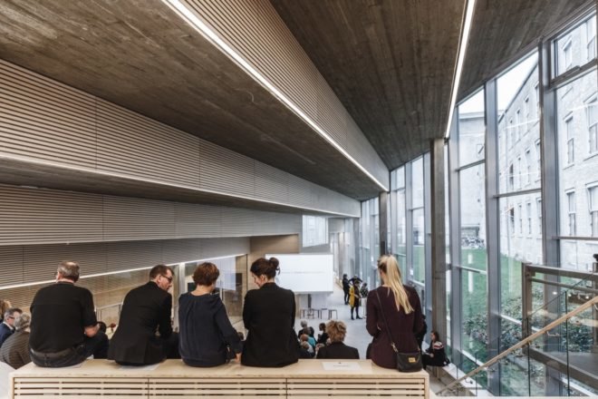 people sitting in room with glass walls