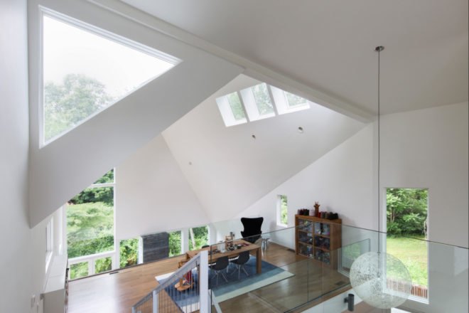 upper floor mezzanine with angular ceiling and multiple windows