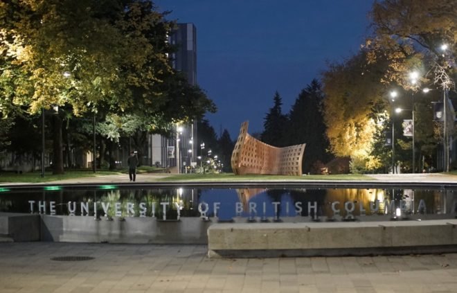 curving wood structure in background with pond in foreground