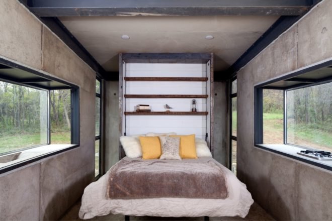 a large bed with two yellow pillows