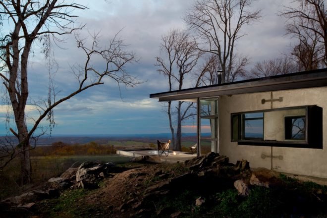 cabin with extended roof jutting out over the landscape