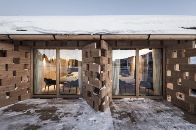 snow covered chalet deck with large windows