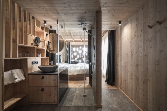wood lined room interior of chalet with glass shower space