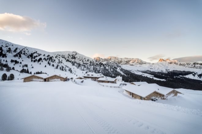 multiple snow covered chalets near mountains