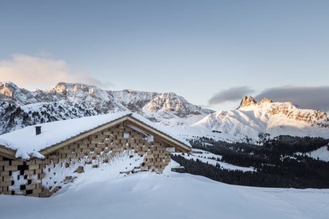 multiple snow covered chalets near mountains