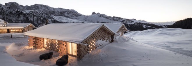 snow covered chalet in mountains