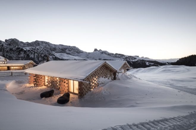 snow covered chalet in mountains