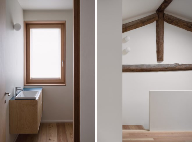 White room with exposed wood ceiling beams