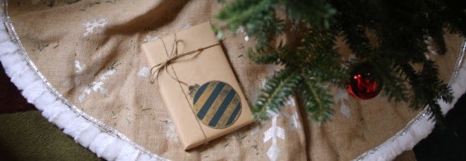 brown paper-wrapped gift under a green tree