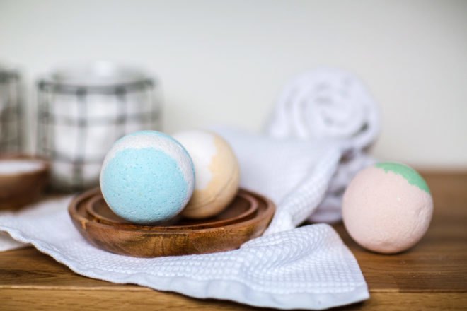 colorful bath bombs on a table with a wash cloth