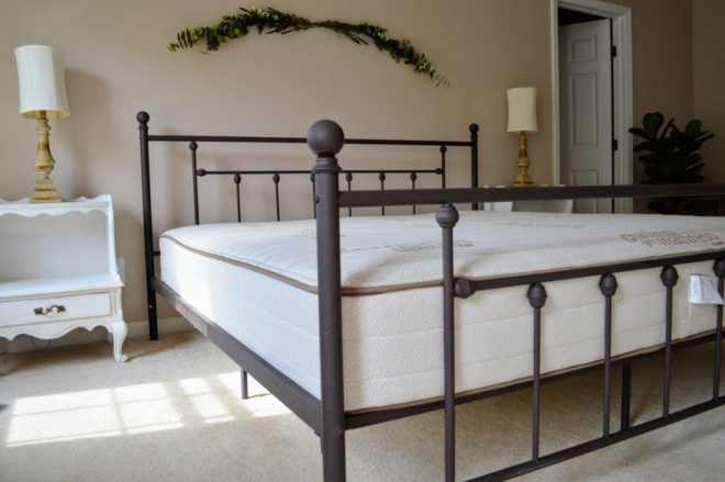 organic, non-toxic mattress on a brown bed frame